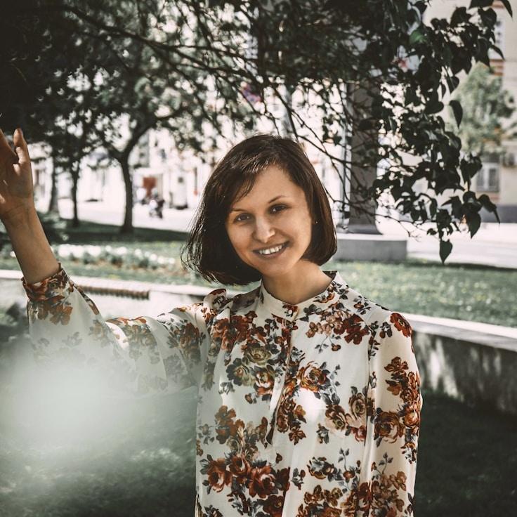Mira Sato, Lead Design Curator at RuralHarborWay, reviewing corporate floral arrangements